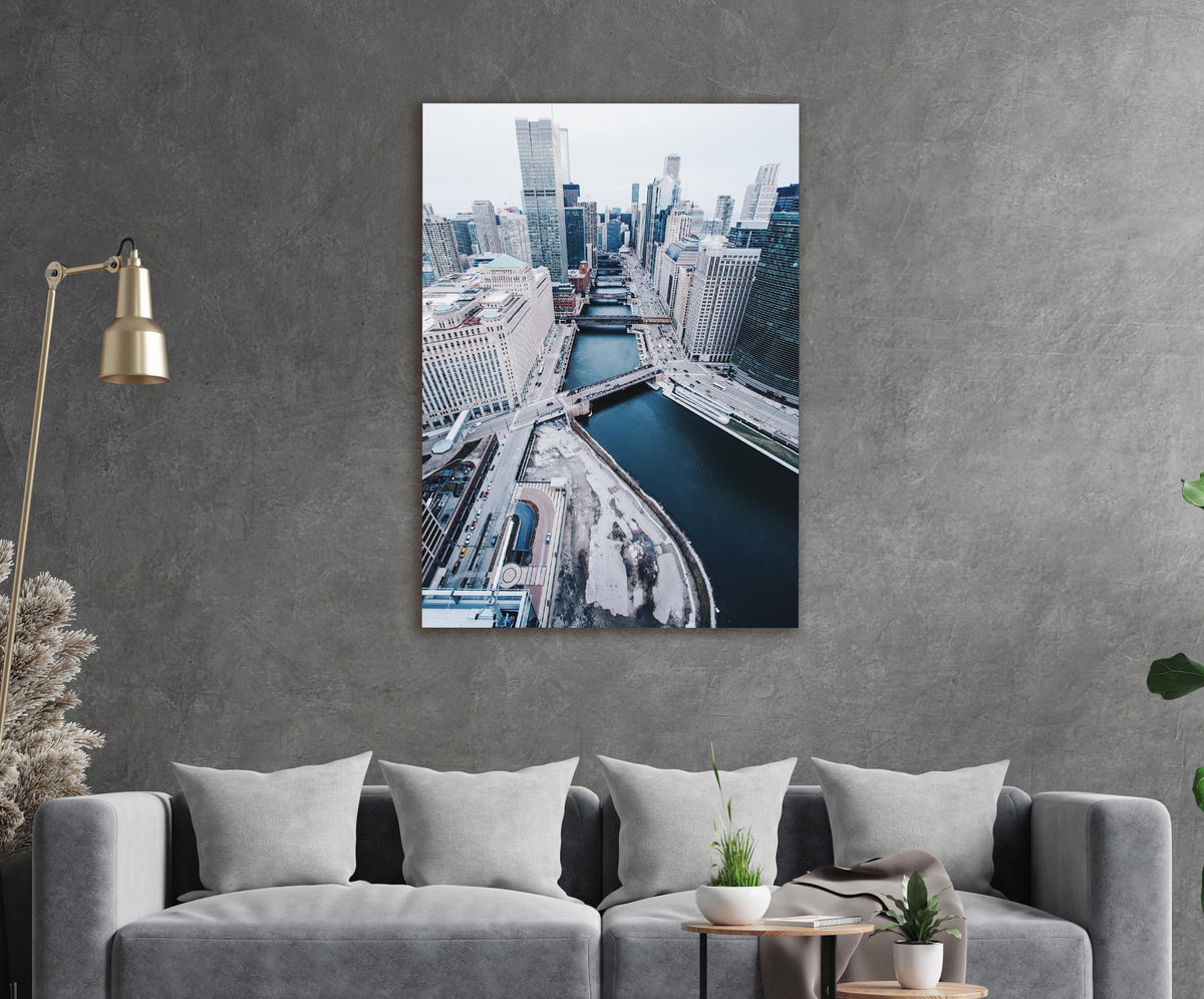 Snowy City River Aerial View Glass Wall Art in a modern interior