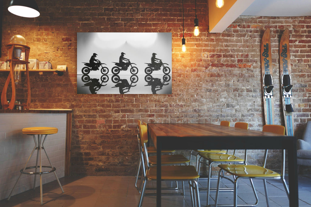 Motocross Riders Silhouette Glass Wall Art in a living room interior