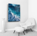 Turquoise Ocean Wave Aerial Glass Wall Art in a living room interior