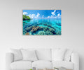 Tropical Lagoon Coral Reef Glass Wall Art in a living room interior