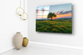 Lone Tree on Sunset Meadow Glass Wall Art in a living room interior