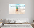 Pineapple on Tropical Beach Glass Wall Art in a living room interior