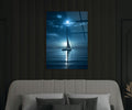 Moonlit Sailboat on Calm Sea Glass Wall Art in a living room interior