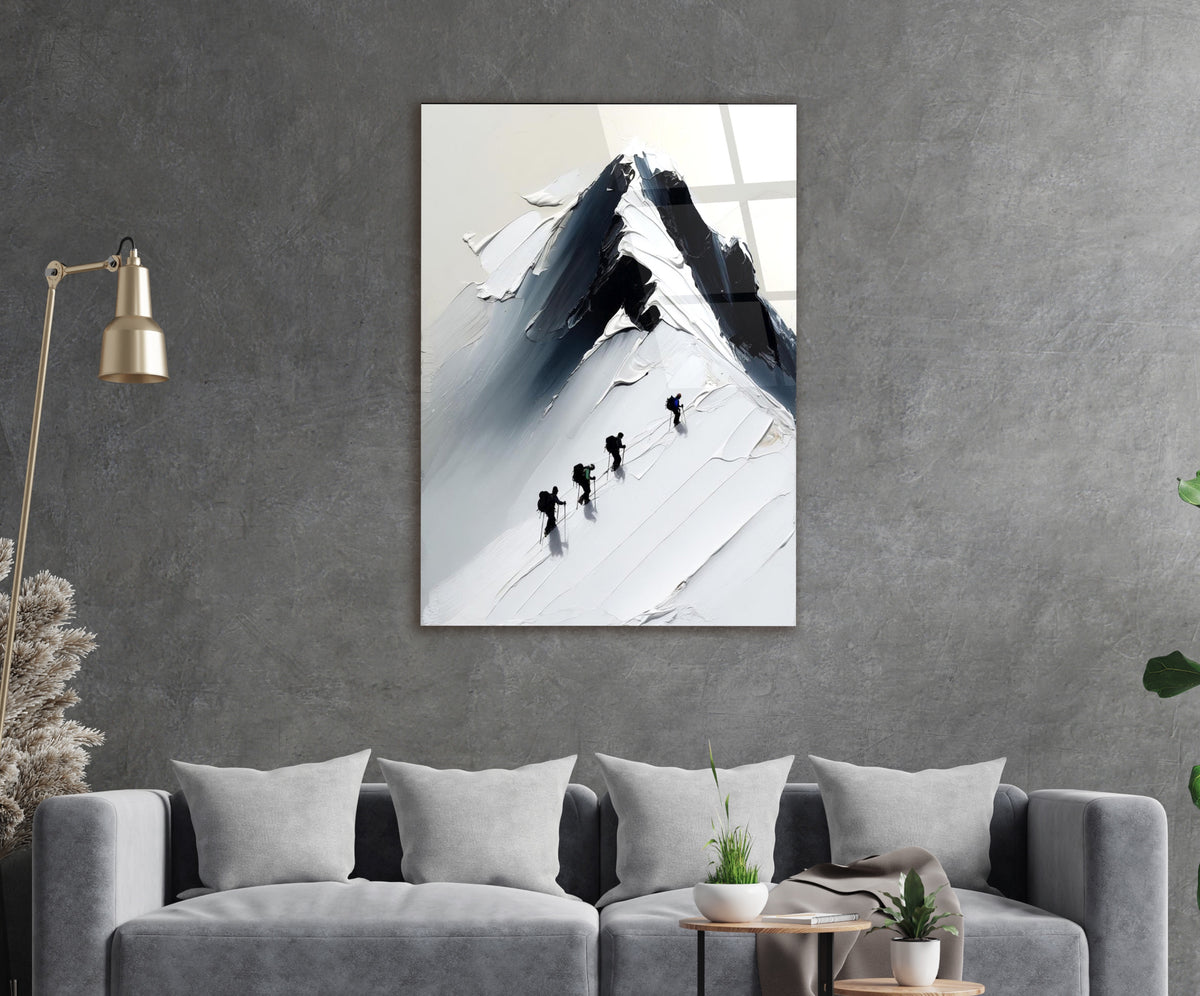 Climbers on a Snowy Mountain Peak Glass Wall Art in a living room interior