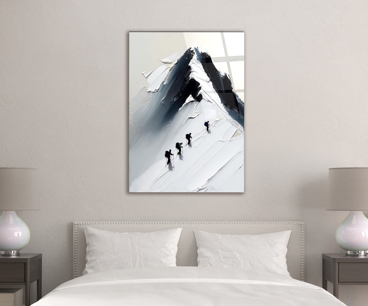 Climbers on a Snowy Mountain Peak Glass Wall Art in a modern interior