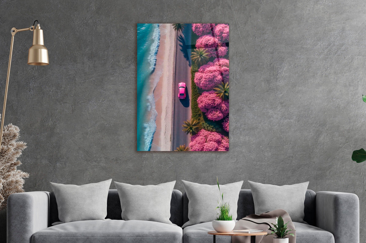 Pink Car on Blossom Beach Road Aerial Glass Wall Art in a living room interior