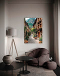 Alpine Village Cobblestone Lane Glass Wall Art in a living room interior