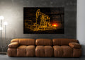 Golden Oil Pumpjack Sunset Glass Wall Art in a living room interior
