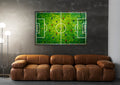Aerial Soccer Pitch Impasto Glass Wall Art in a living room interior
