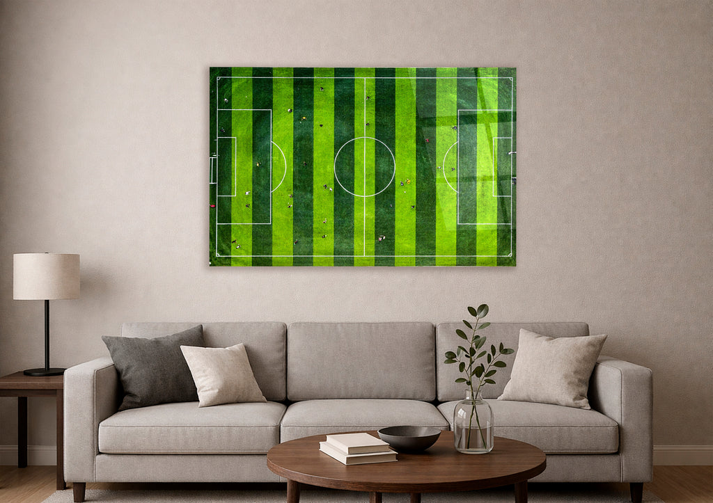 Aerial Soccer Field Glass Wall Art in a living room interior