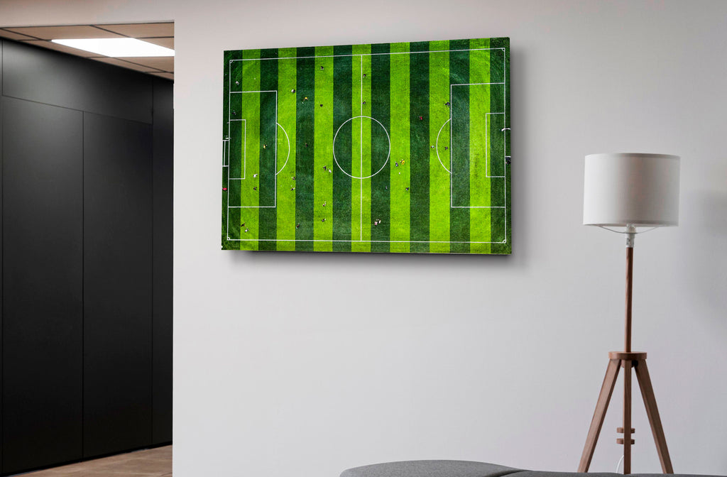 Aerial Soccer Field Glass Wall Art in a modern interior