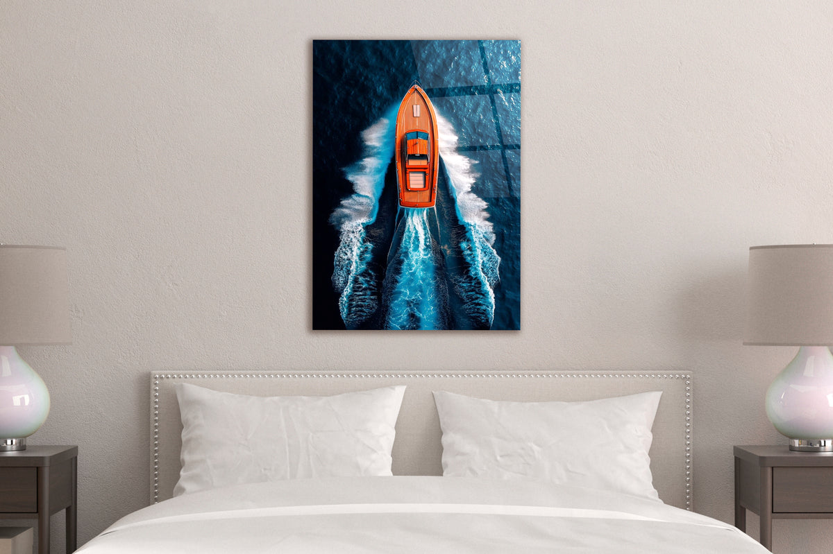 Orange Speedboat Aerial Ocean Glass Wall Art in a living room interior