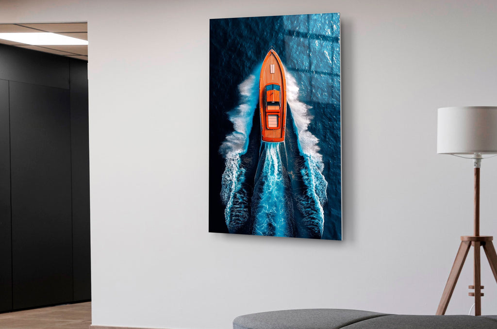 Orange Speedboat Aerial Ocean Glass Wall Art in a modern interior
