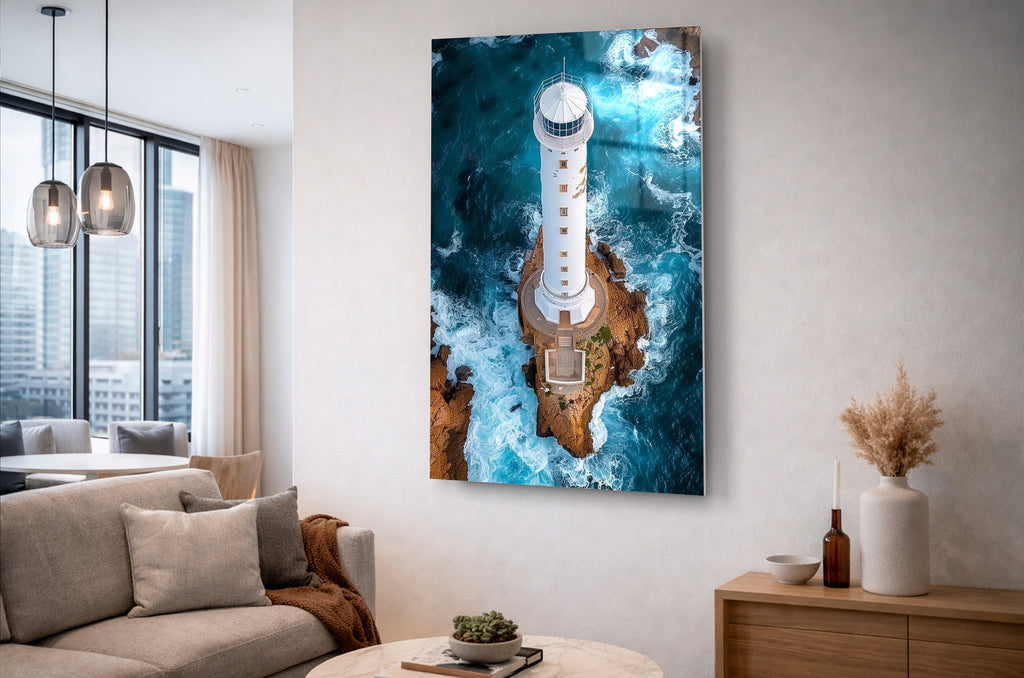 Aerial Lighthouse Ocean Waves Glass Wall Art in a living room interior