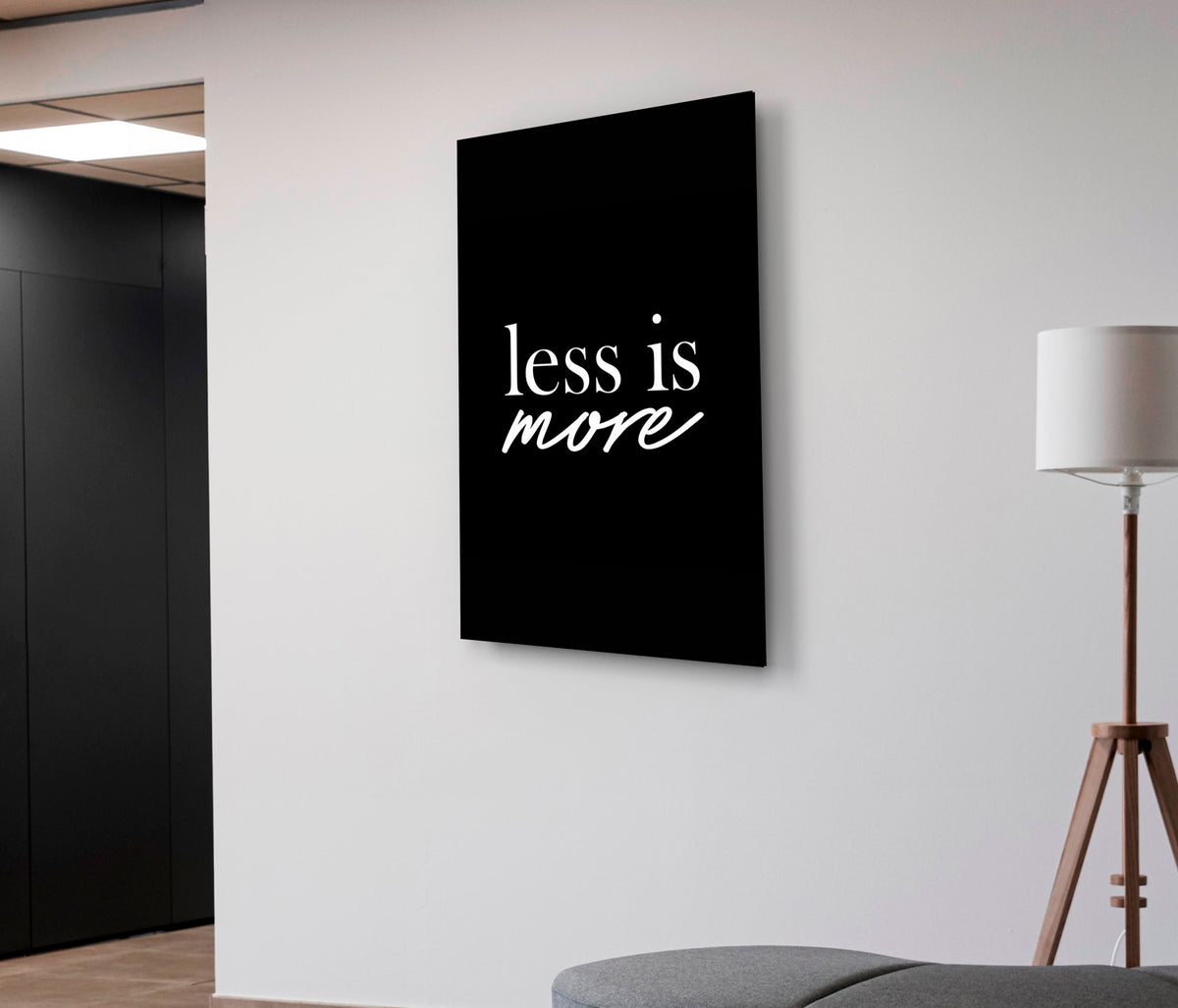 Less Is More Minimalist Quote Glass Wall Art on the wall